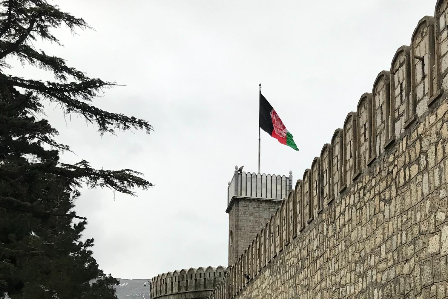 Afghan flag flies over a fortress wall in Kabul