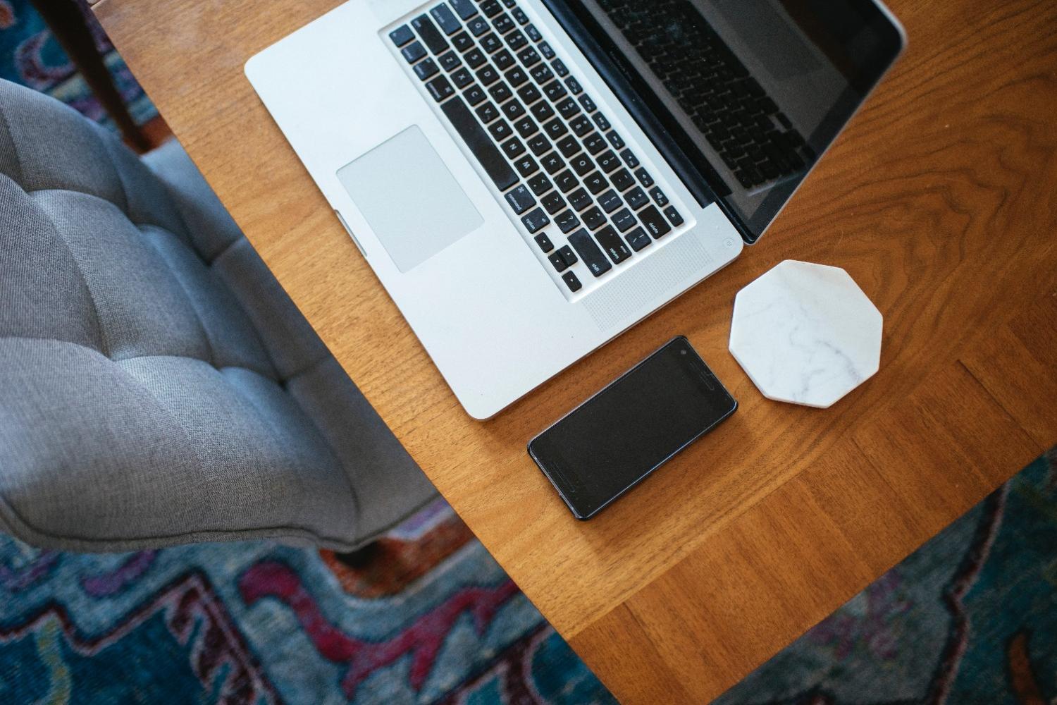 A laptop and phone in a clean workspace