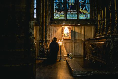 Woman Praying before an Icon