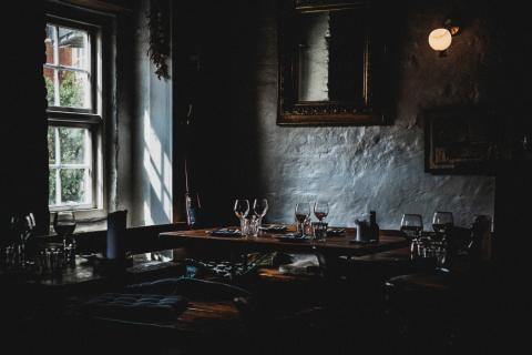 A window-side table set at a tavern