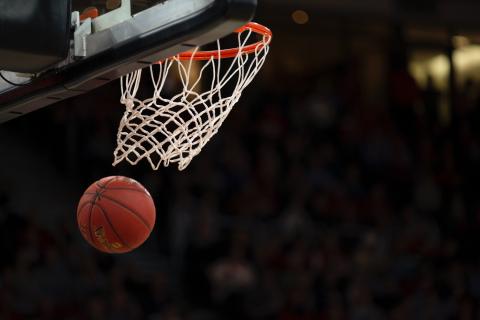 A basketball flies through the hoop