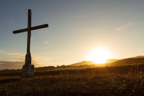 A cross faces the sunrise