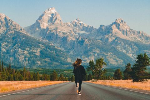 A woman running into the mountains