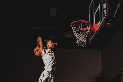 An athlete dunking